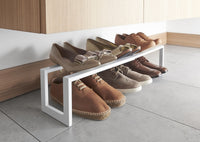 Yamazaki's adjustable white shoe rack filled with brown shoes, seen up close